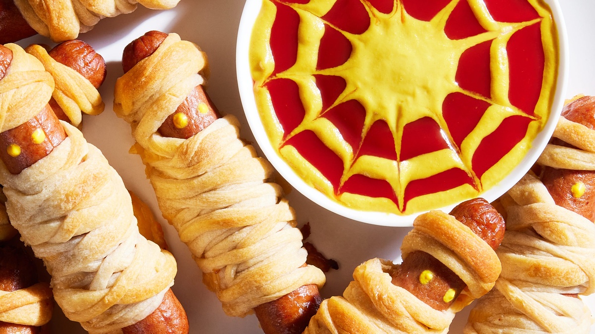 Würstchenmumien mit Senf und Tomatensoße serviert