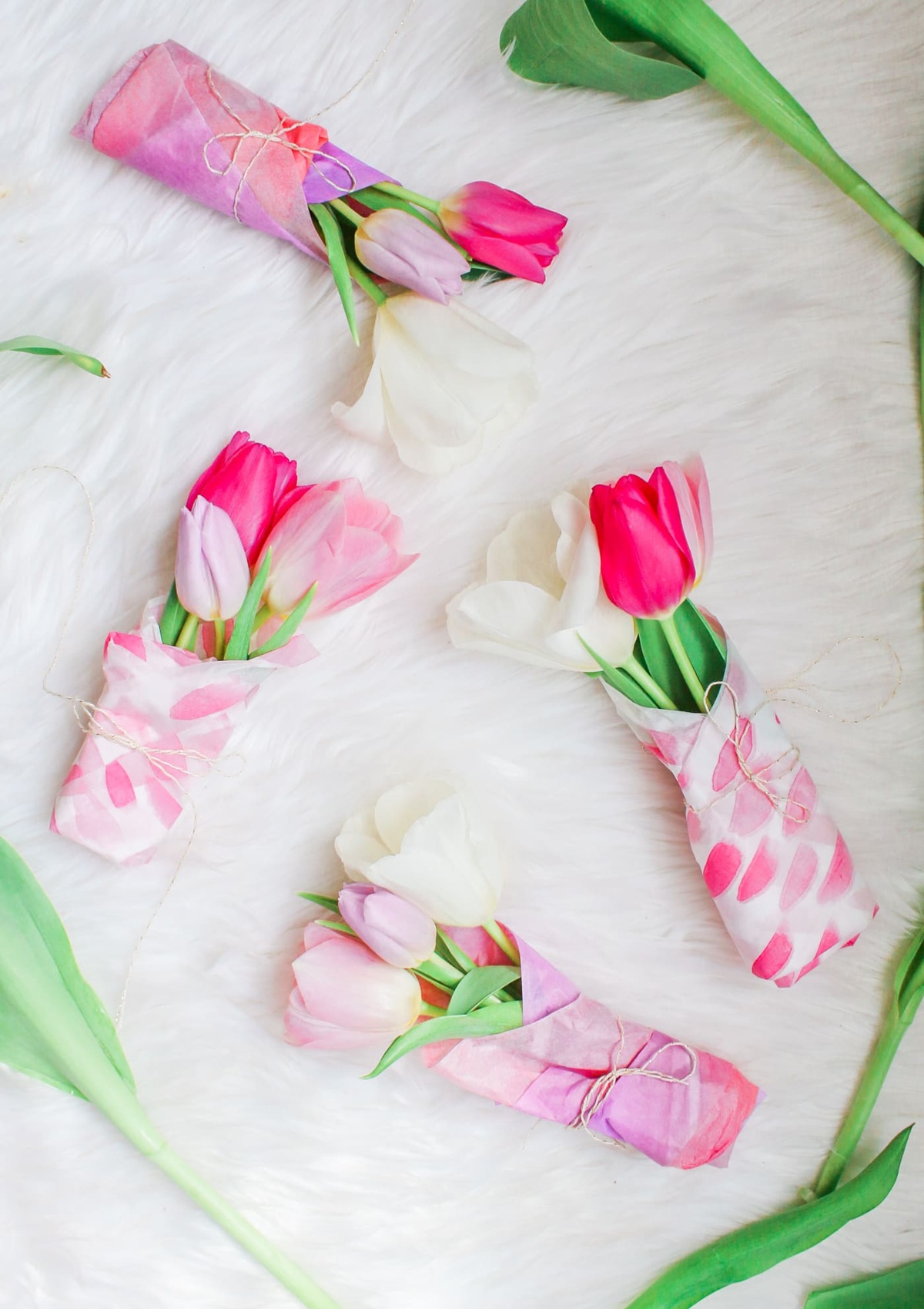 Servietten falten und je drei Tulpen darin stecken